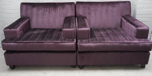 A pair of modern purple upholstered square back armchairs, on tapering ebonised supports, 95cm wide x 81cm high.