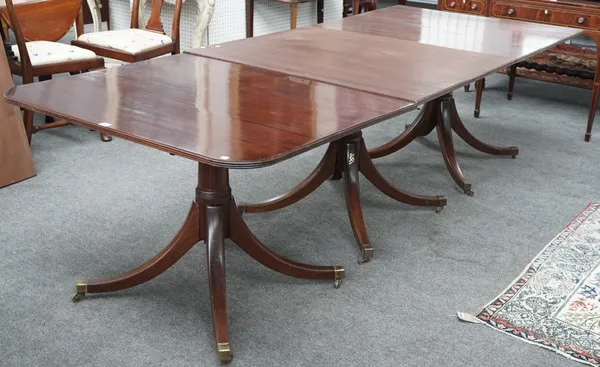 A Regency style mahogany four pillar extending dining table on downswept supports, four extra leaves (one 'D' end section missing), 107cm wide x 438cm