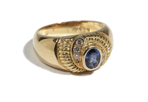 An 18ct gold, sapphire and diamond-set dress ring of bombe design, the oval-cut sapphire collet set in a surround of circular-cut diamonds, ring size