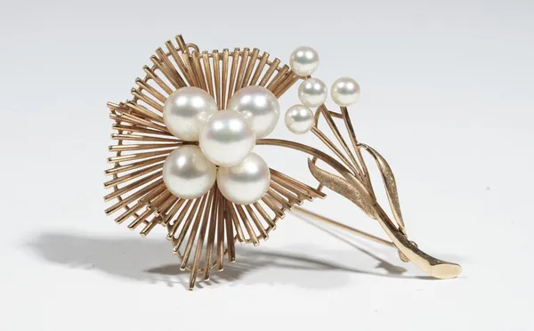 A gold and cultured pearl brooch, of abstract flower design, set with cultured pearls to the flowerhead and leaf, on a pin detailed K14, 5.5cm long, 1