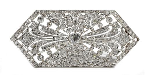 An Art Deco style diamond-set brooch of lozenge shaped plaque design, the principal circular-cut diamond weighing approximately 0.50ct, milligrain-set