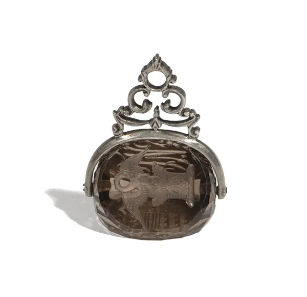 A 19th century silver mounted smoky quartz fob seal, intaglio carved to three sides with a monogram, a crest of a bird above a turret and a shield, he