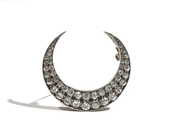 A Victorian diamond-set crescent brooch, claw-set with old mine-cut diamonds, approximate total diamond weight 2ct, set in a silver and gold backed se