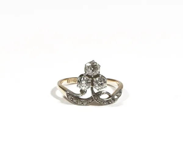 An 18ct gold and diamond-set dress ring of trefoil design, claw-set with old mine-cut diamonds,between diamond set shoulders, ring size K, gross weigh