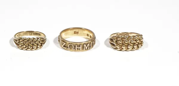 An 18ct gold band ring, with applied Greek symbols, London 1873, ring size P, and two 18ct gold knotwork rings, ring size M, 17.2g gross, Birmingham 1