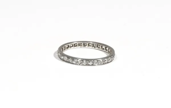 A diamond-set eternity ring, claw-set with circular-cut diamonds, ring size L, 1.8g gross.