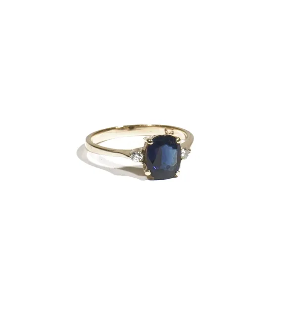 A gold, sapphire and diamond dress ring, the oval-cut sapphire four claw-set with two circular-cut diamonds to the shoulders, ring size M, 2.2g gross,