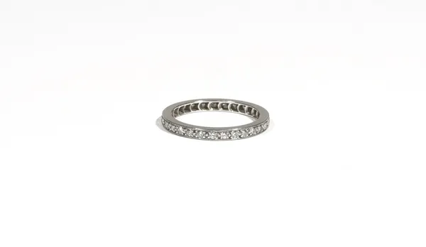 A diamond-set eternity ring, claw-set with circular-cut diamonds, to a white precious metal mount, ring size K, 2.6g gross.