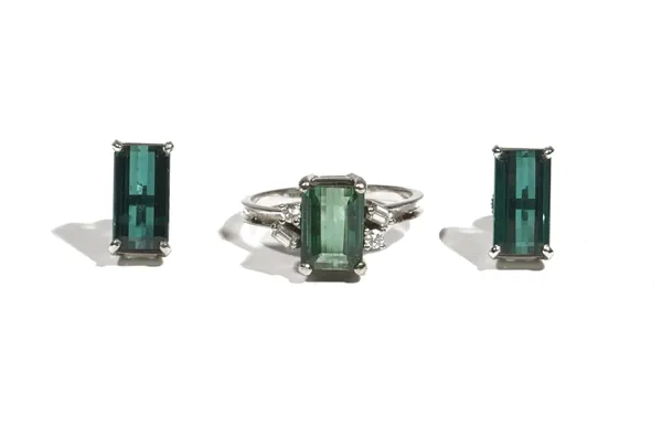 A green tourmaline and diamond-set dress ring, the rectangular cut-cornered step-cut tourmaline four claw-set with circular and baguette-cut diamonds