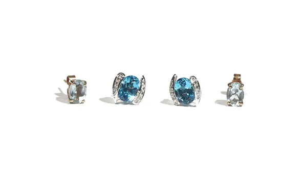 A pair of 18ct white gold, blue topaz and diamond-set earstuds, the oval-cut blue topaz, between diamond set shoulders, to butterfly back fittings; an