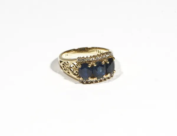 A gold, sapphire and diamond-set dress ring, the three oval-cut sapphires, claw-set between two rows of circular-cut diamonds to the sides, the shank