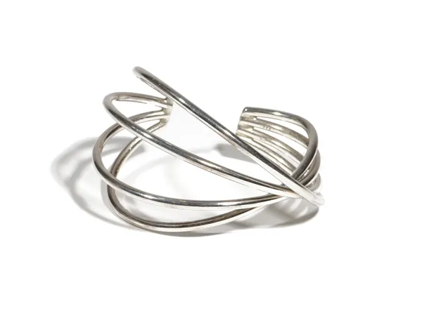 A modern silver torc bangle by Georg Jensen, of four bar cross-over design, contained with original box.