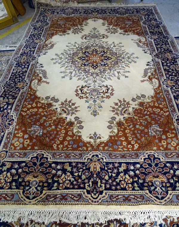 An Indian carpet, the ivory field with central medallion, 285cm x 190cm.