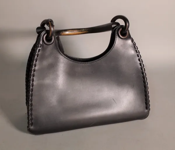 A Gucci black leather handbag, with ebonised wooden handle, 29cm wide.