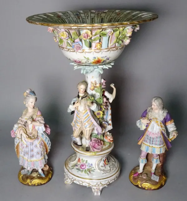 A pair of late 19th century Limoges porcelain figures of a man and a woman, and a Continental figural centrepiece, 37cm tall, (3).