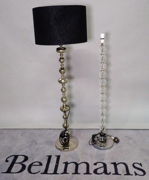 A modern floorstanding glass standard lamp on bobbin turned column and chrome base, 113cm high, and another similar chrome standard lamp, 135cm high,