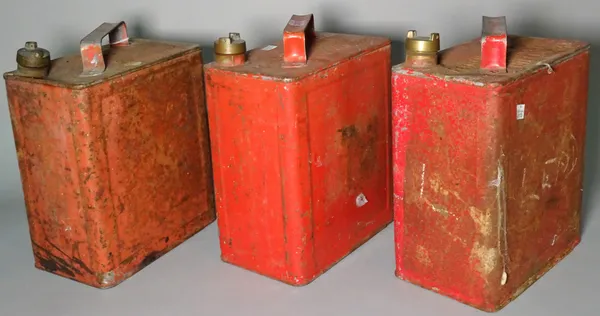 A group of three early 20th century red painted petrol cans, 25cm wide x 28cm high, (3).