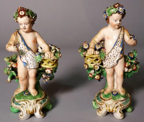 A pair of Continental porcelain figures of Putto, 12cm high, (a.f.), (2).