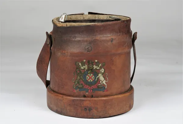 A 19th century leather bound shot carrier with a coat of arms to the front, 30cm diameter x 33cm high.