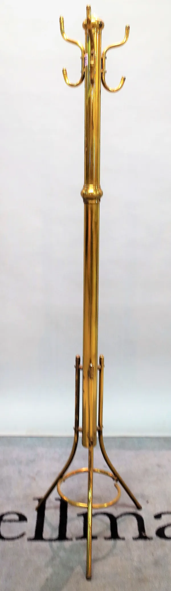 An early 20th century brass coat stand on three outswept supports, 177cm high.