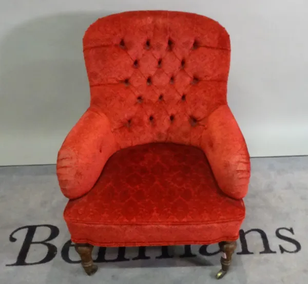 A late Victorian stained beech framed low armchair, with red foliate upholstery on fluted tapering supports, 66cm wide x 82cm high.