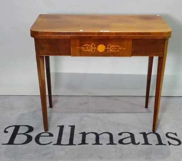 An early 19th century inlaid mahogany French foldover tea table on tapering square supports, 89cm wide x 78cm high.