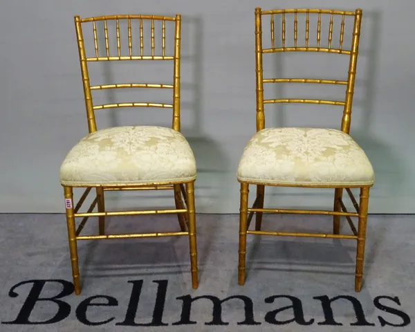 A pair of early 20th century gold painted faux bamboo side chairs, 42cm wide x 85cm high, (2).