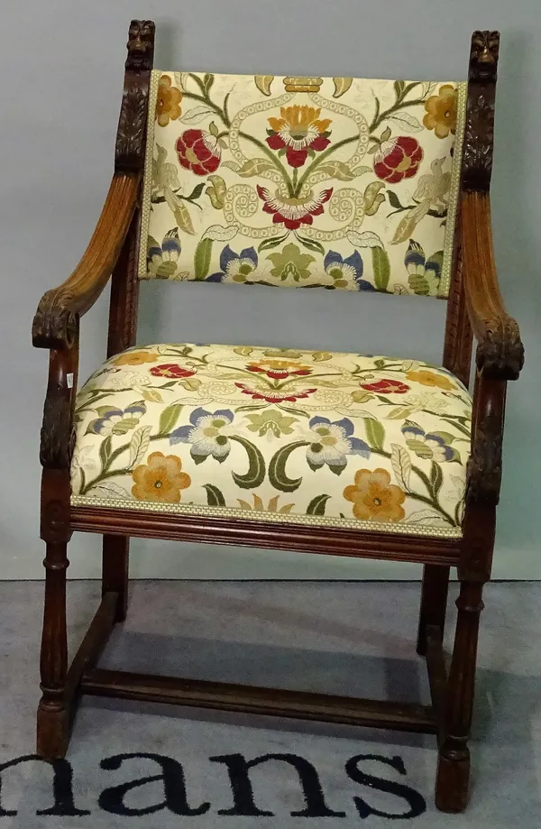 An 18th century style mahogany framed bar square back open armchair with carved lion surmounts, 58cm wide x 97cm high.