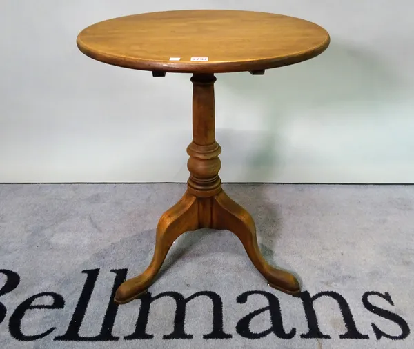 A George III style mahogany tripod table on a turned column on three downswept supports, 60cm diameter x 72cm high.