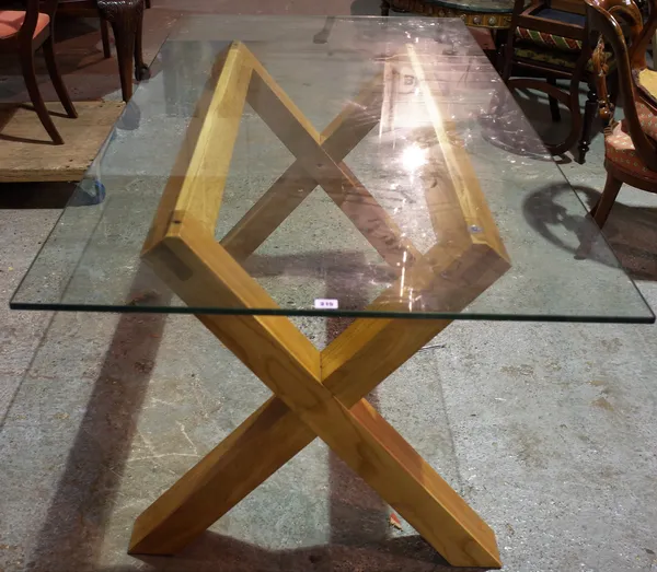 An oak and glass rectangular dining table on X-frame base, 180cm wide x 80cm high.