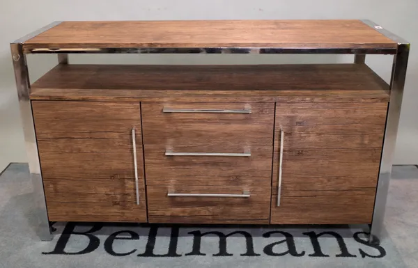 A hardwood side cupboard with three short drawers flanked by cupboards on chrome supports, 128cm wide x 78cm high.