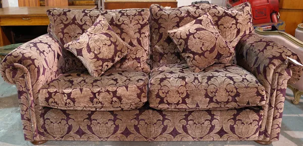 'DURESTA'  a two seater sofa with roll over arms and foliate upholstery, 200cm wide x 80cm high.