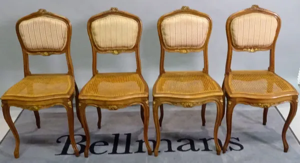 A set of four Louis XV style walnut parcel gilt chairs, 42cm wide x 88cm high, (4).