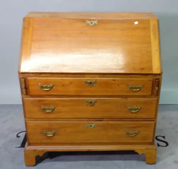 A walnut bureau with three long graduated drawers on bracket feet, 91cm wide x 101 cm high.