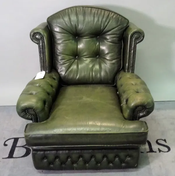 A 20th century green leathered upholstered wingback armchair, 83cm wide x 92cm high.