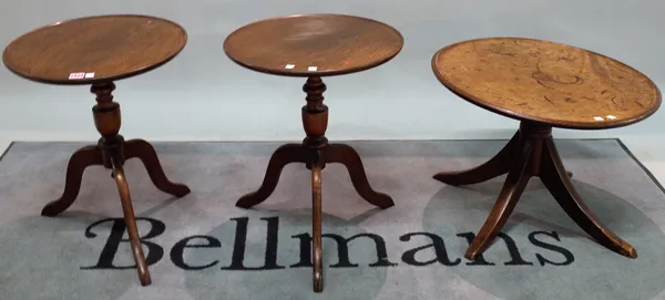 A pair of 19th century oak low tripod tables with downswept supports, 44cm high x 54cm high, and another similar table, 69cm diameter x 43cm high, (3)