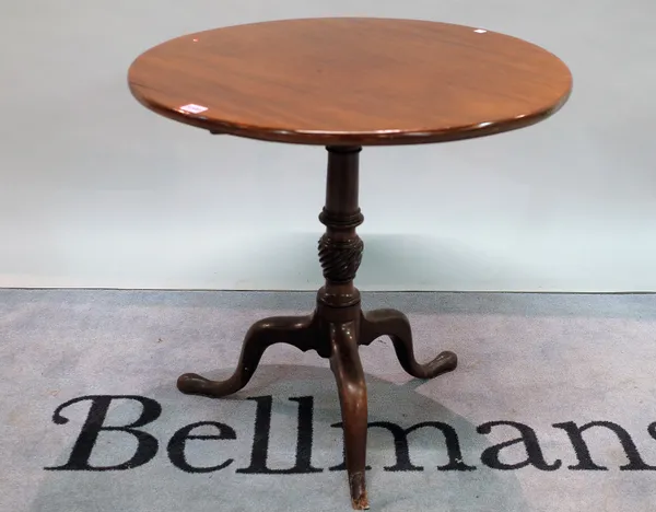 A George III mahogany tripod table on turned column and downswept supports, 70cm diameter x 70cm high.