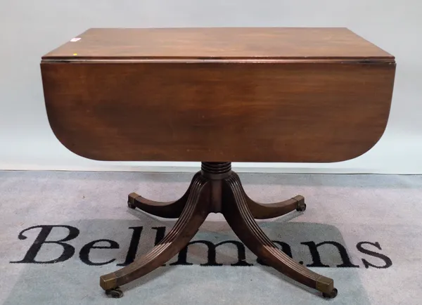 A George III mahogany drop flap Pembroke table with turned column on four outswept supports, 87cm wide x 71cm high.