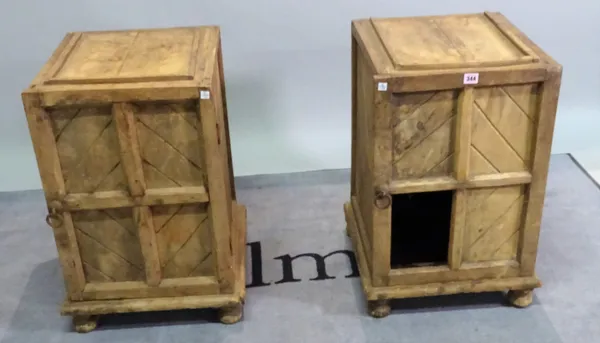 A pair of early 20th century hardwood bedside cupboards with panelled doors on bun feet, (a.f.), 41cm wide x 67cm high, (2).