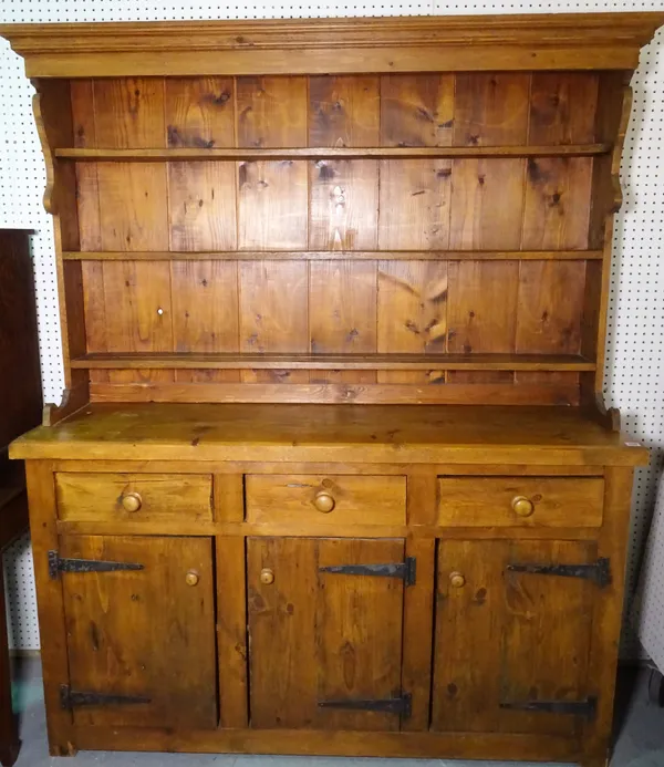 A 20th century pine kitchen dresser with a three tier plate rack over three short drawers, 157cm wide x 192cm high.