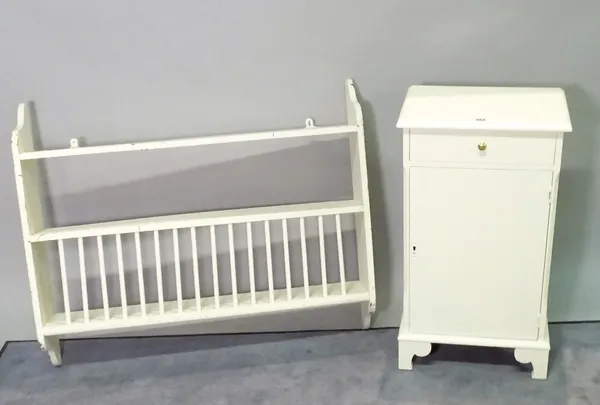 A 20th century white painted single drawer bedside cupboard, 41cm wide x 74cm high, and a white painted hanging plate rack, 92cm wide x 79cm high.