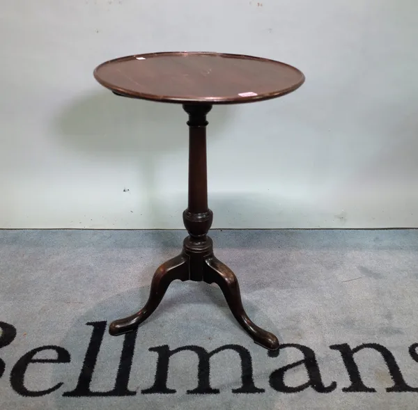 A George III mahogany tripod table with circular dished top on downswept supports, 46cm diameter x 65cm high.