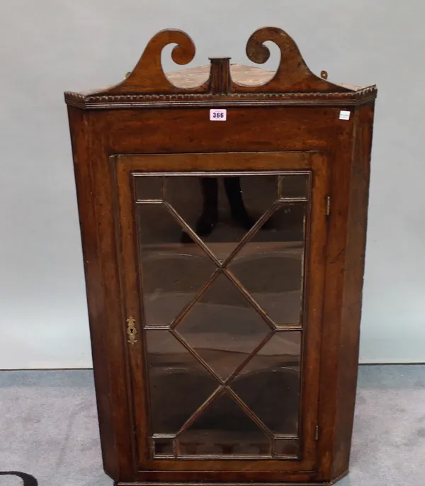 A George III mahogany hanging corner cupboard with glazed door, 62cm wide x 110cm high.