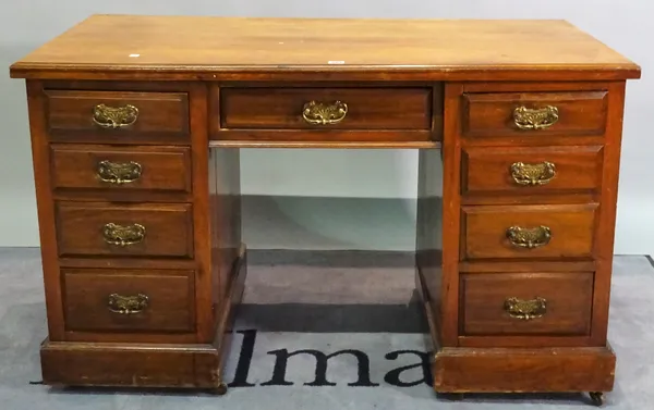 An early 20th century mahogany writing desk with nine drawers about the knee, 77cm high.