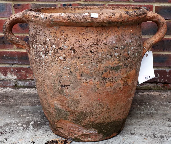 An early 20th century terracotta twin handled urn, 56cm wide x 43cm high.