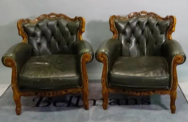 A pair of Victorian style stained beech armchairs with green leather upholstery, 84cm wide x 89cm high, (2).