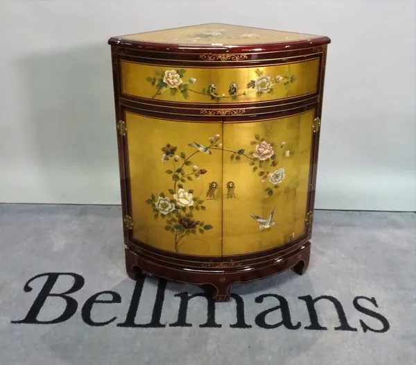 An early 20th century Japanese red and gold lacquer single drawer corner cupboard, 71cm wide x 92cm high.