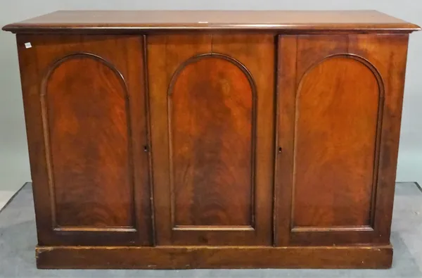 A Victorian mahogany side cabinet with three arch panel doors, 140cm wide x 94cm high.