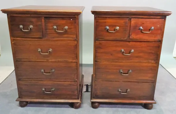 A pair of 20th century stained beech chests of two short and three long drawers on bun feet, 57cm wide x 86cm high, (2).