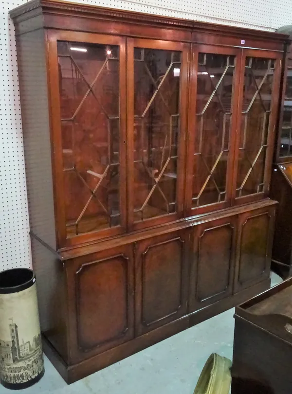 A George III style mahogany bookcase cabinet astragal glazed doors on a plinth base (cut in two sections), 178cm wide x 195cm high.